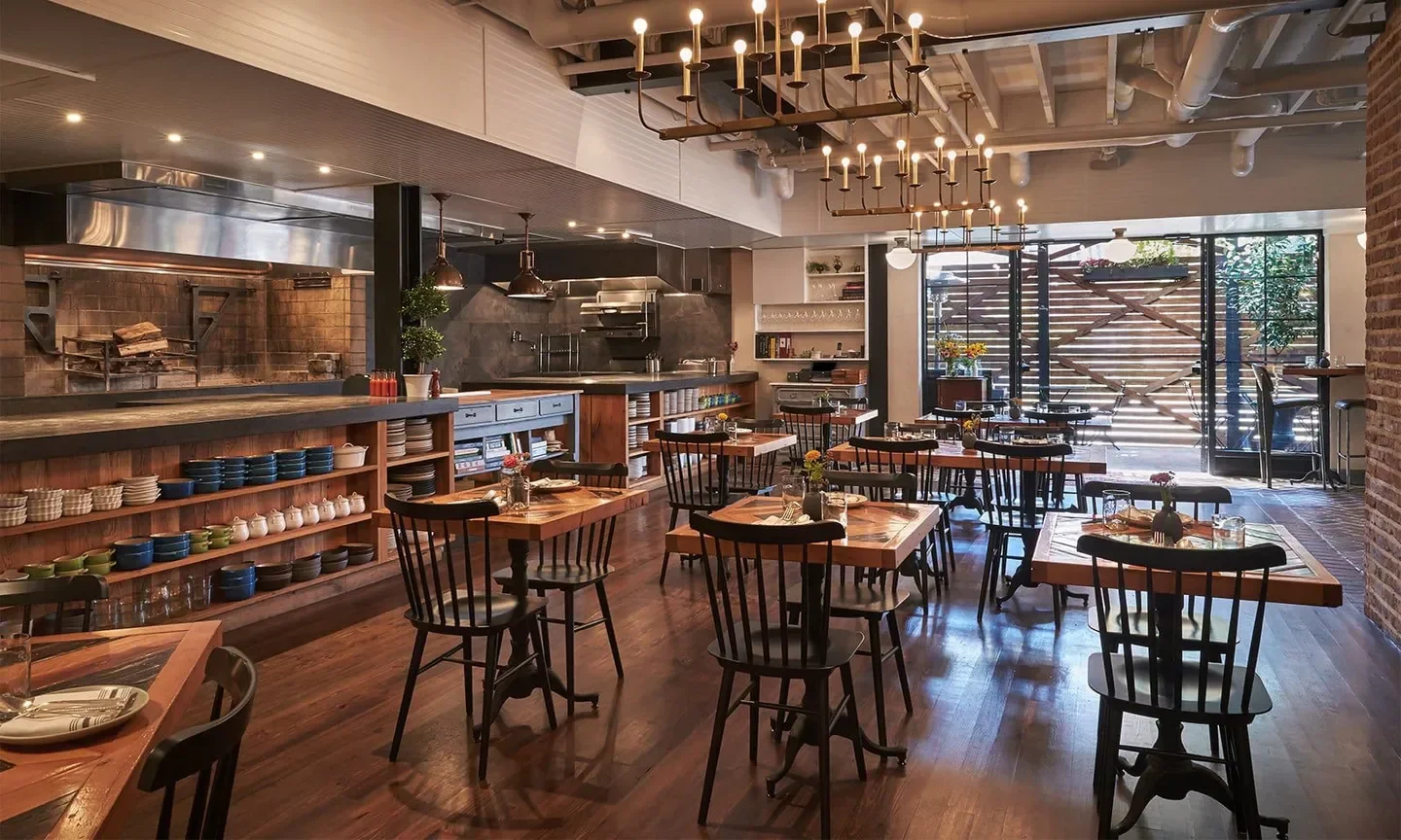 Interior of The Dabney restaurant in Washington, showcasing elegant dining room with open kitchen