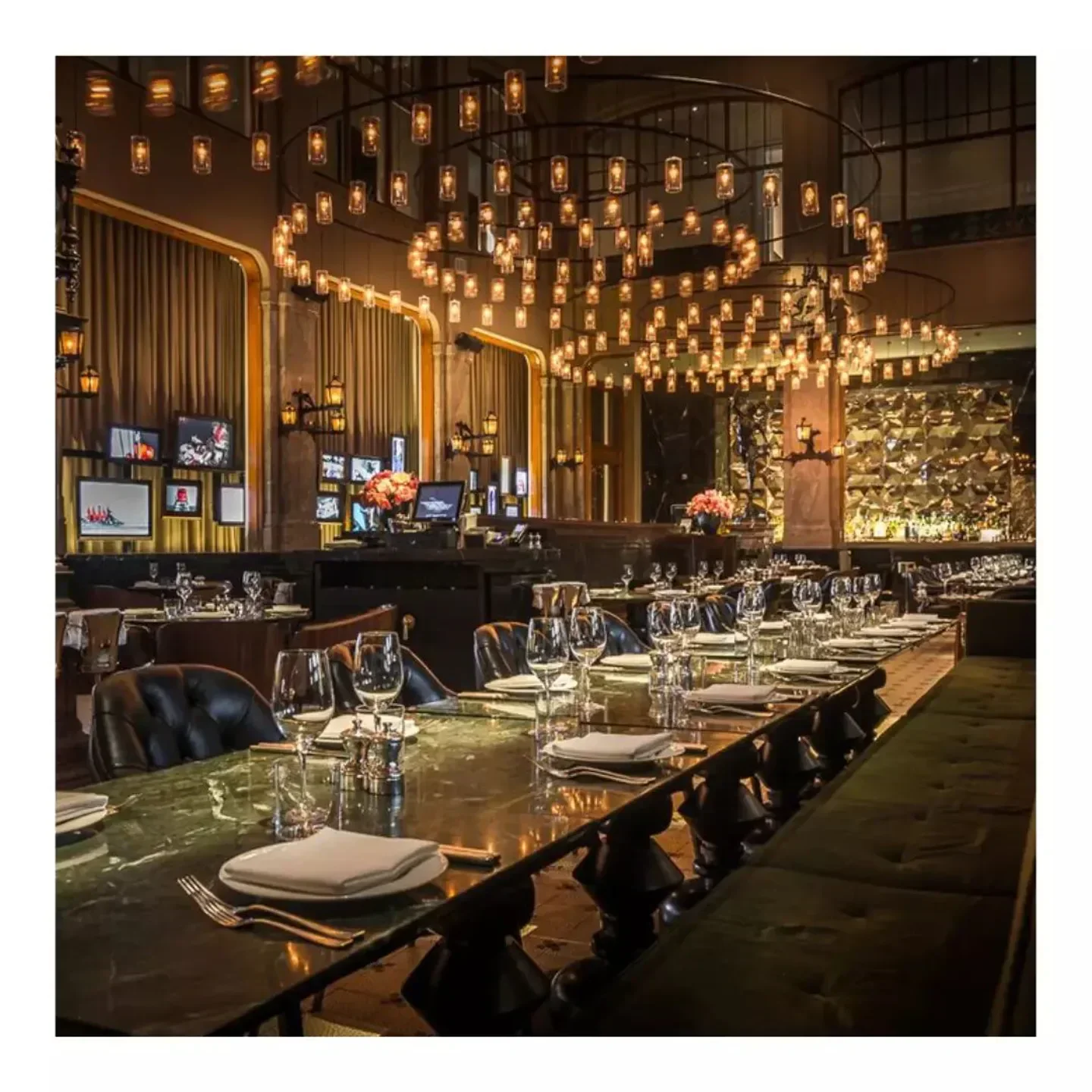 Elegant dining room interior at The Duchess restaurant in Amsterdam with striking chandelier.