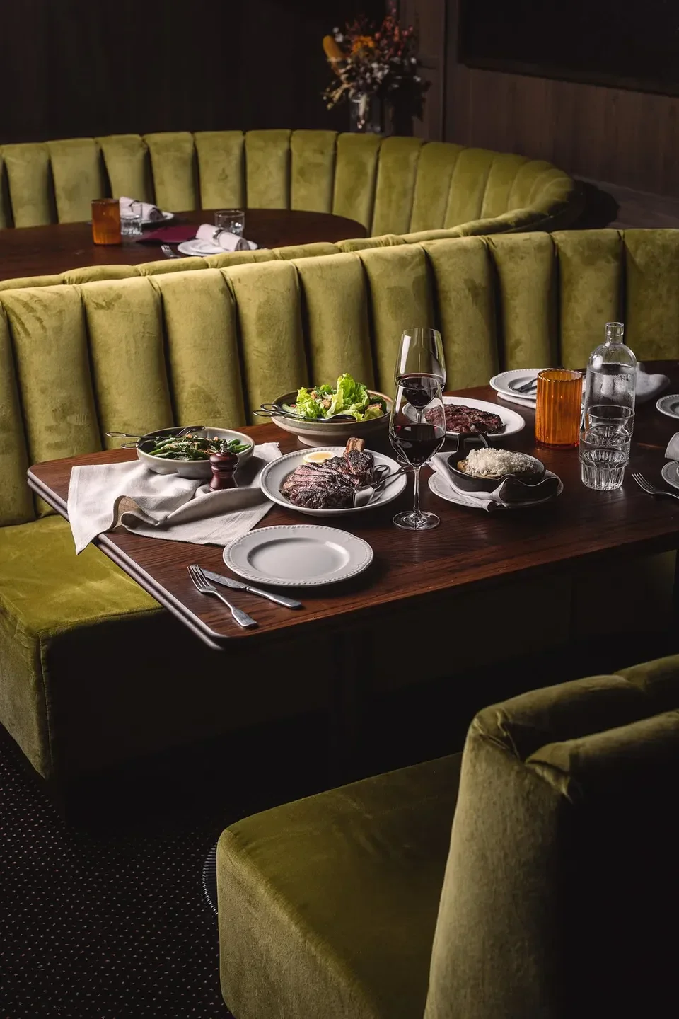 Steak and wine at The Gidley restaurant in Sydney, set on a velvet booth table