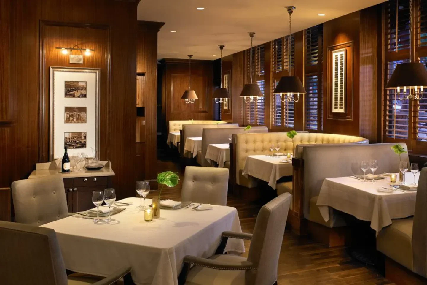Elegant dining room at The Grant Grill in San Diego, featuring cozy booths and dim lighting.