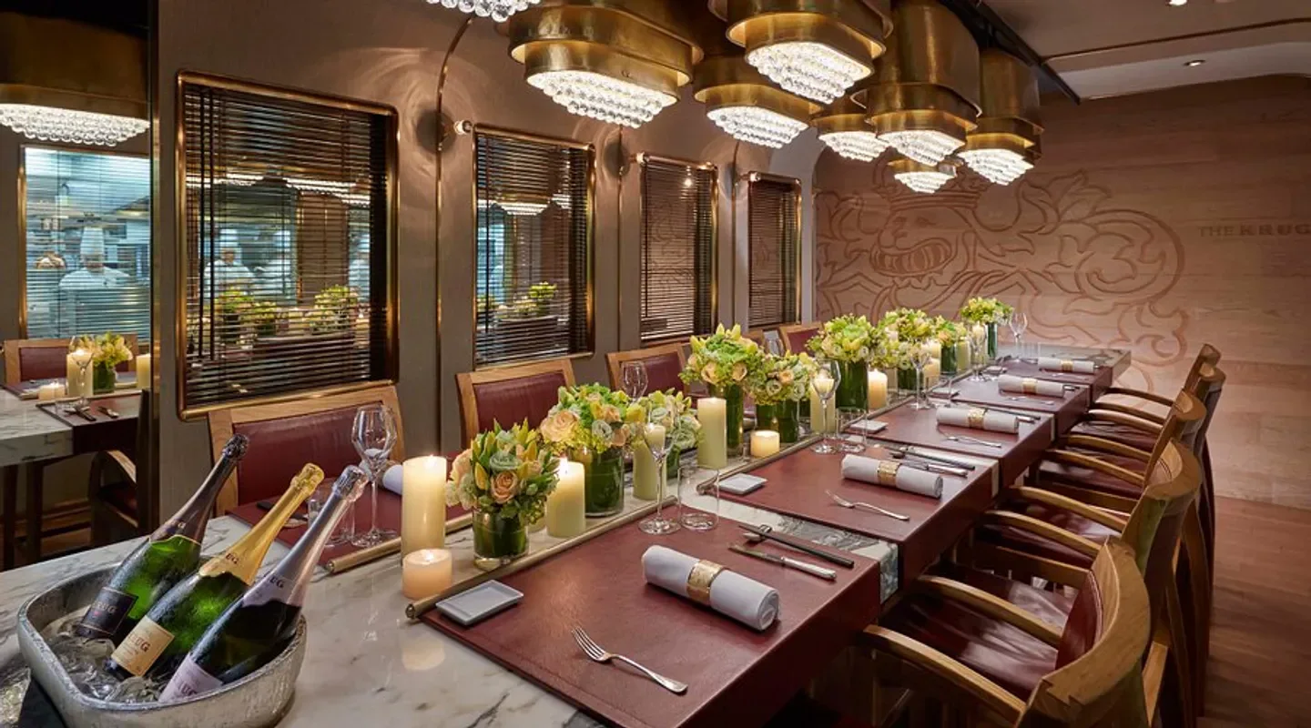 Elegant dining at The Krug Room in Hong Kong, featuring floral arrangements and champagne.