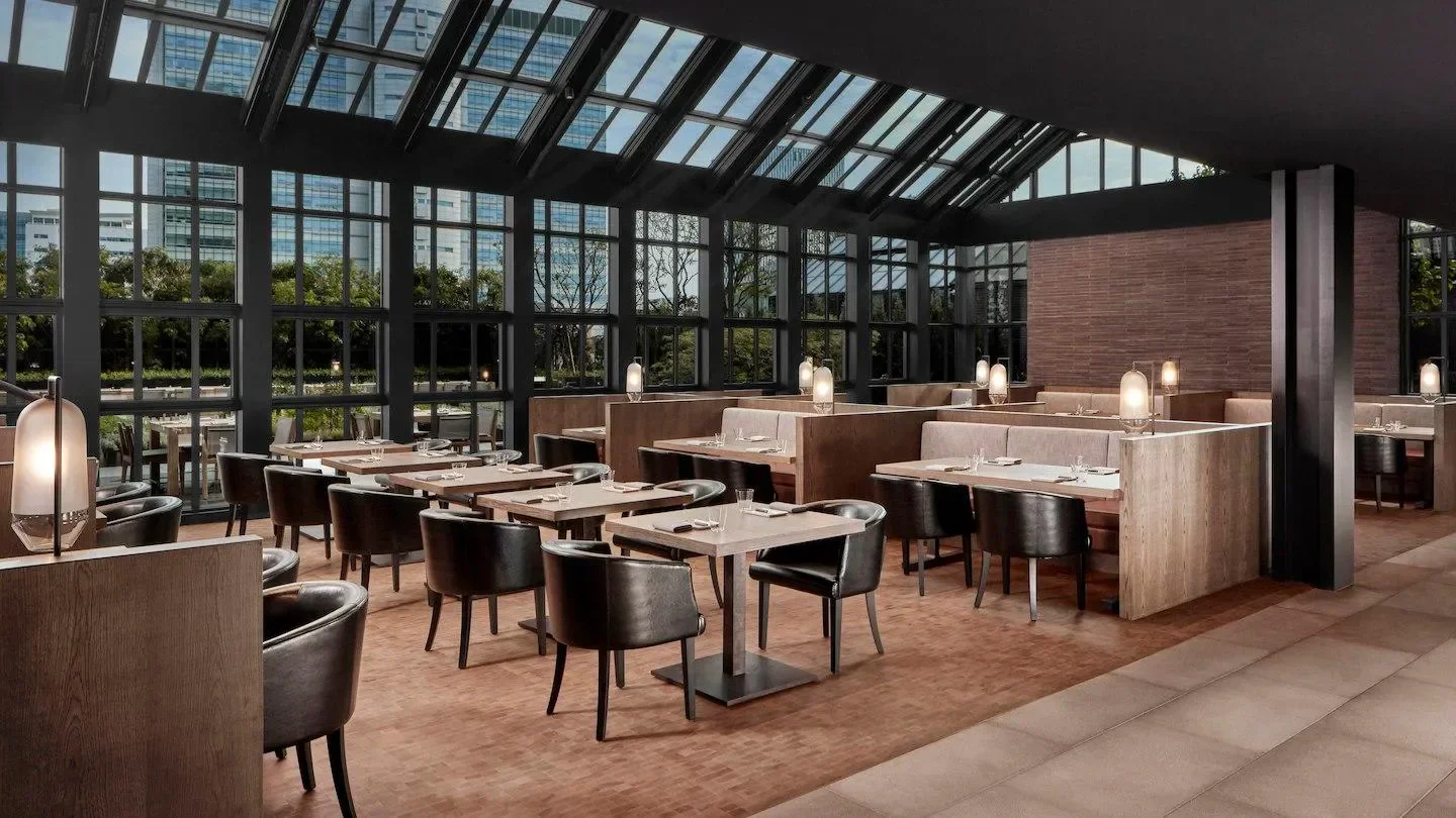 Interior of The Margaux Grill restaurant in Seoul with seating and large windows