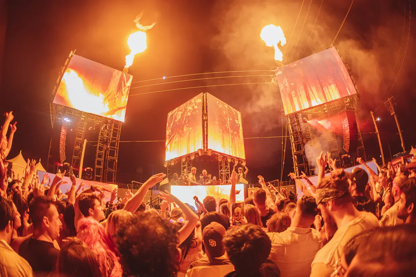Energetic crowd at The Midway in San Francisco, with stage visuals and fire effects.