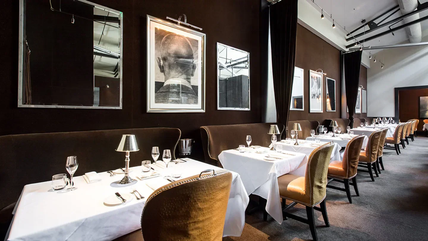 Elegant dining room interior at The Morris in San Francisco with artwork and tables.