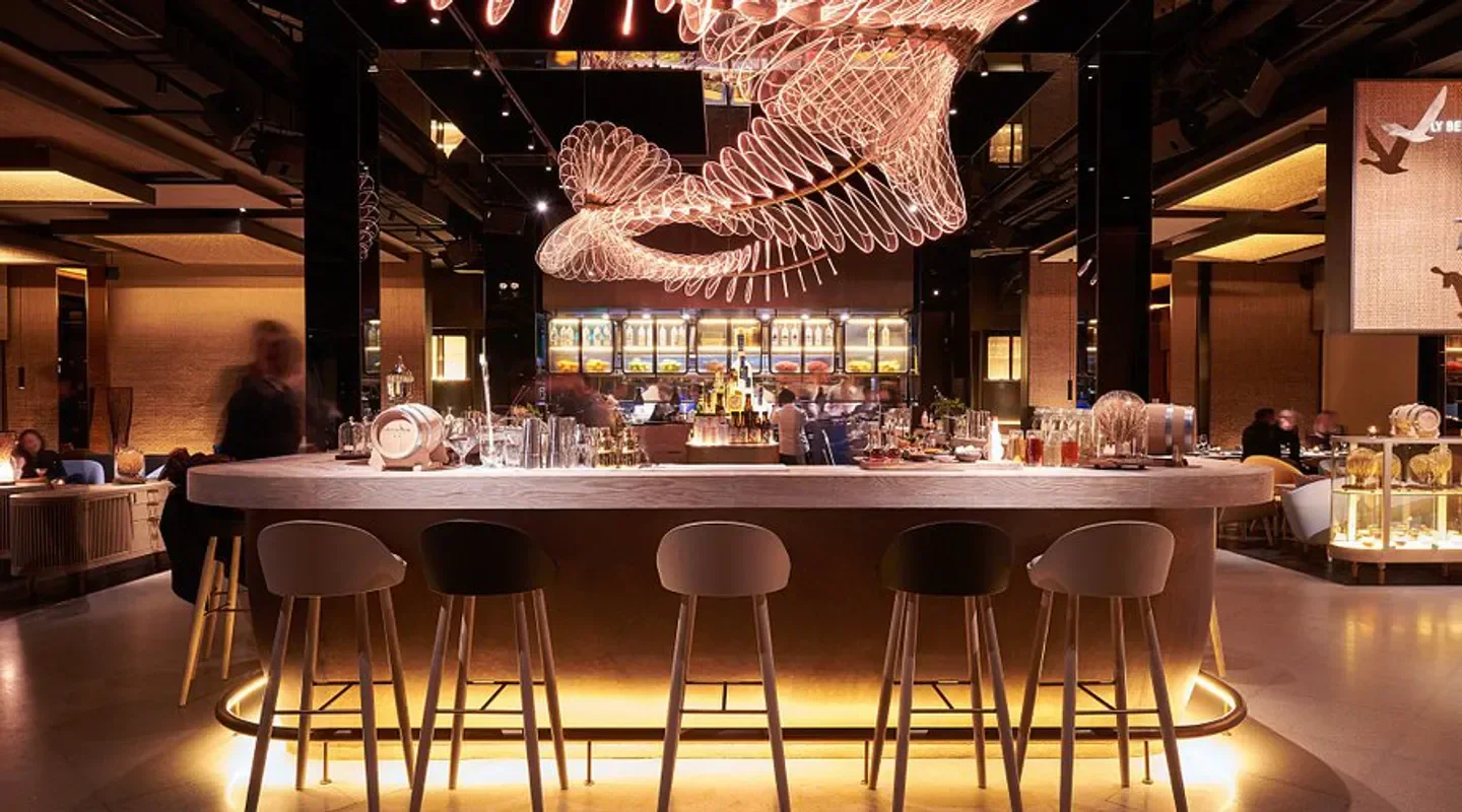 Stylish bar at The Nest restaurant in Shanghai, featuring modern lighting and seating.
