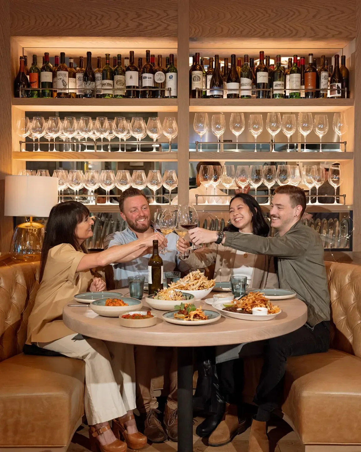 Friends toasting at The Oakville Grill & Cellar in Chicago, enjoying dinner and wine.