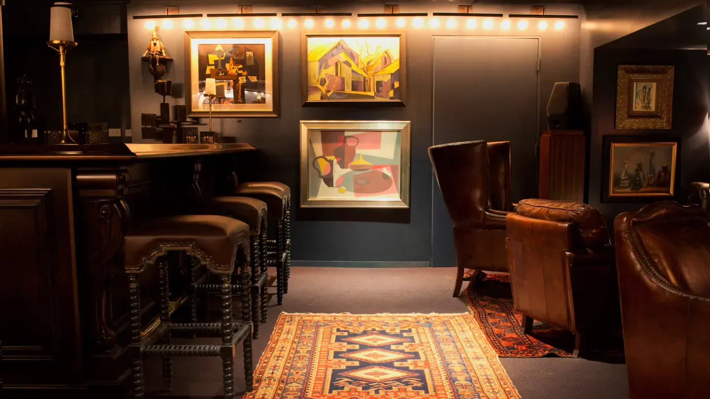 Interior of The Office in Chicago with leather stools and artwork.