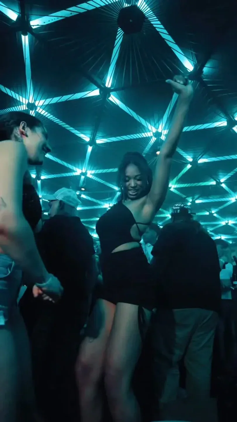 Dancing at The Pearl nightclub in Berlin, under futuristic neon lighting.