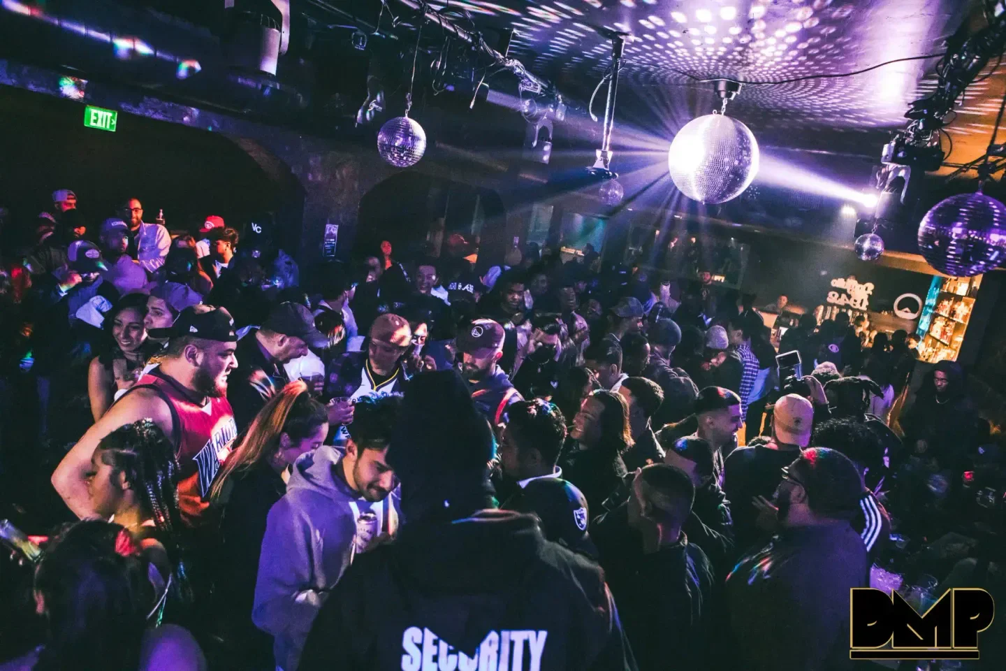Nightclub scene at The Valencia Room in San Francisco with crowd and disco balls