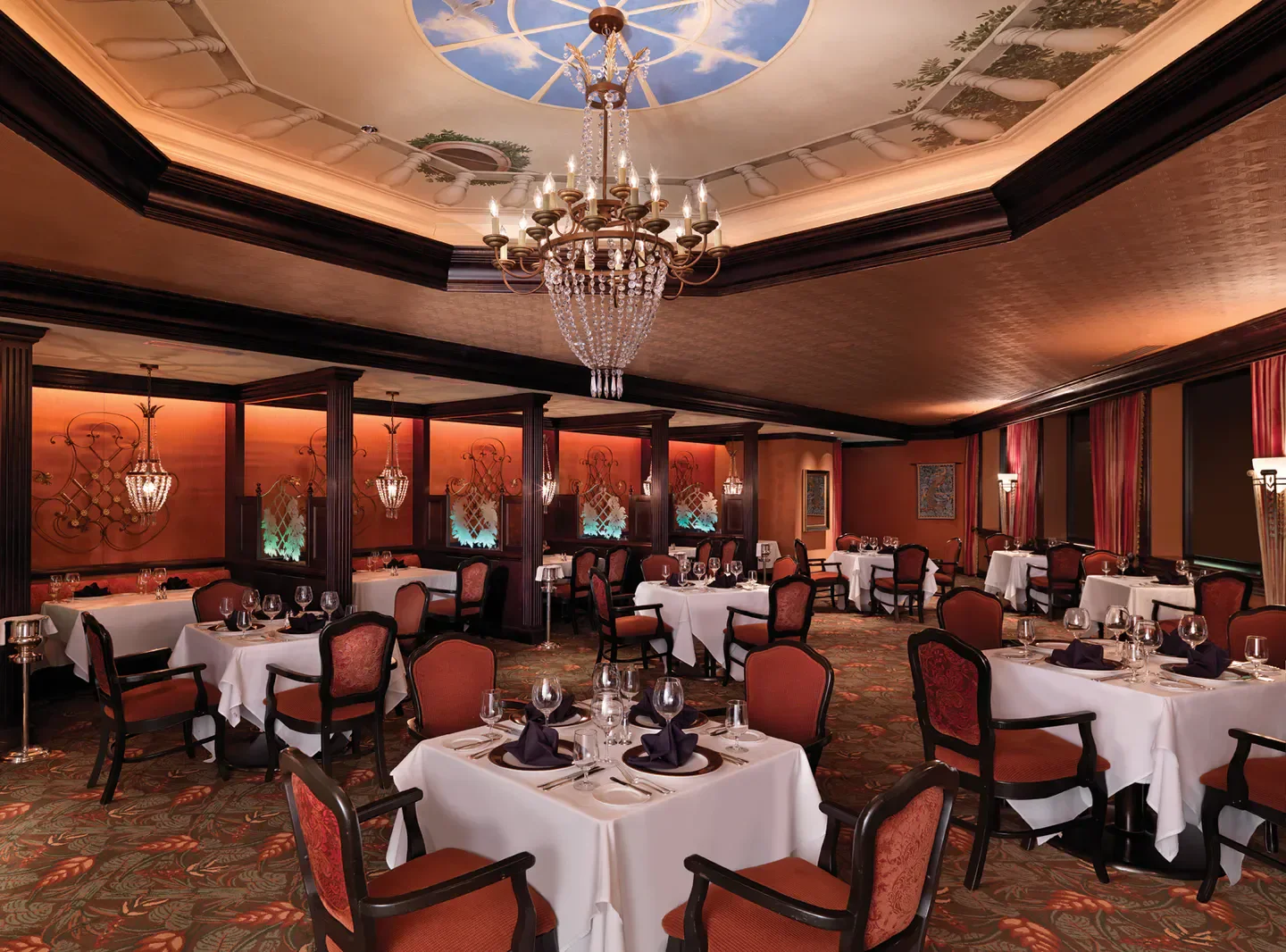 Elegant dining room at The Venetian Chop House in Orlando, featuring a stunning chandelier.