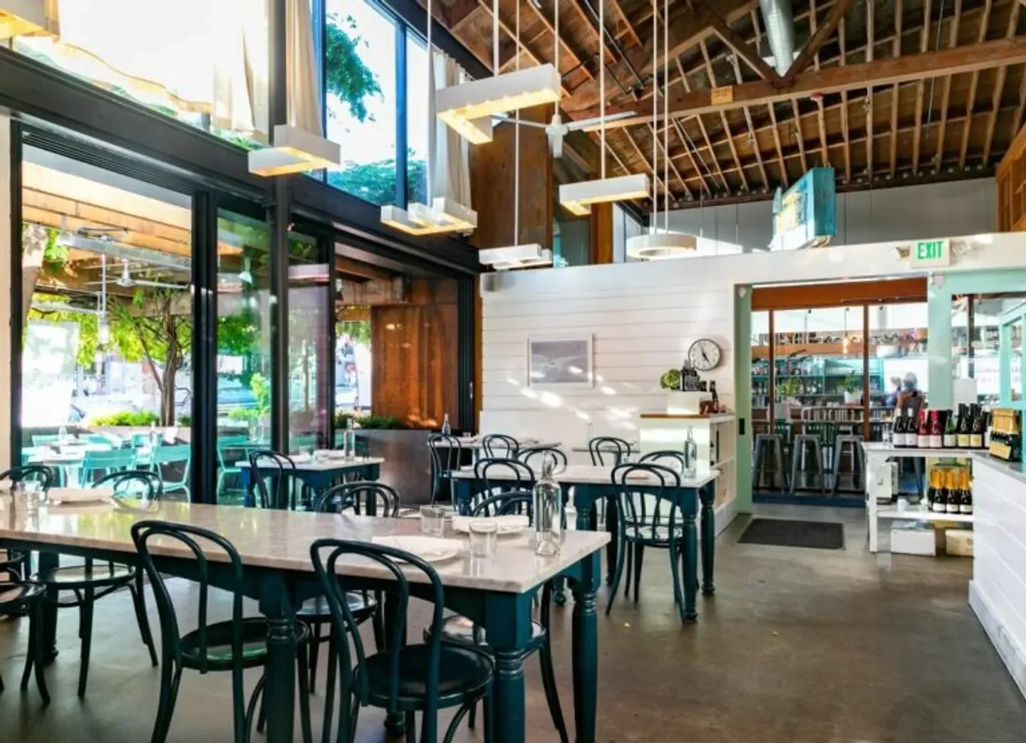 Interior of The Whale Wins restaurant in Seattle, showing tables and open space.
