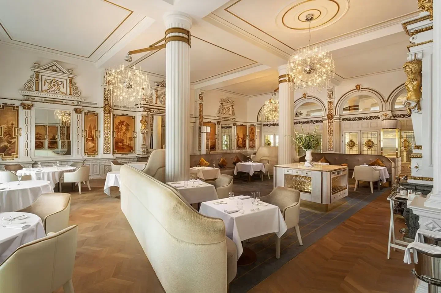 Elegant dining room interior at The White Room restaurant in Amsterdam with chandeliers.
