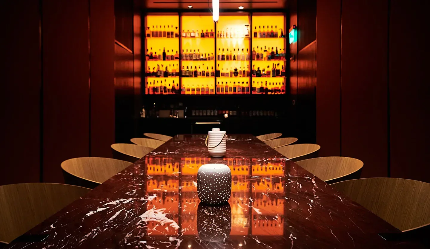Interior of The Wild restaurant in San Francisco with a long red marble table.