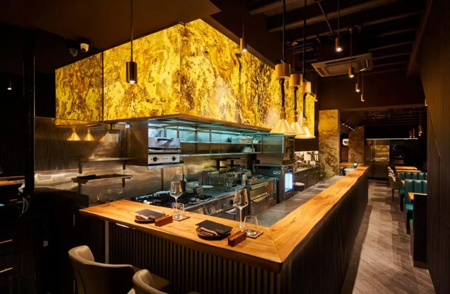 Interior view of Thevar restaurant in Singapore, featuring a stylish bar and kitchen area.