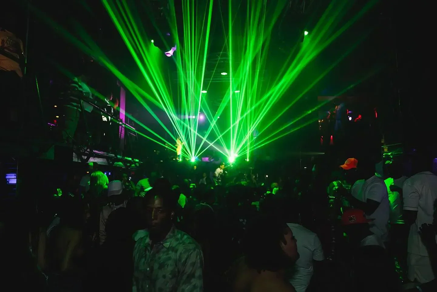 Tier nightclub in Orlando with green laser lights and a crowd of people