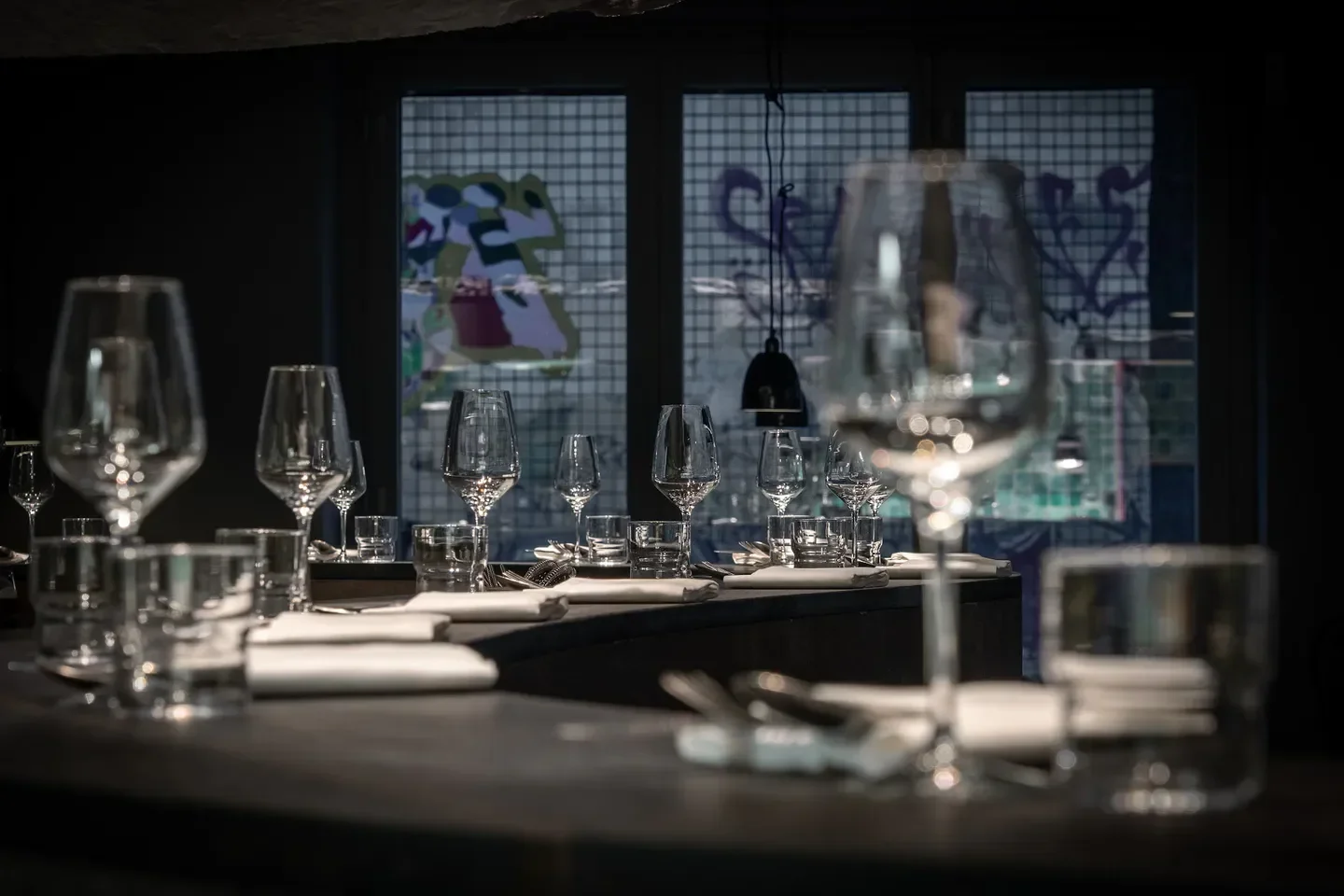 Elegant table setting at TISK restaurant in Berlin, with wine glasses and tableware.