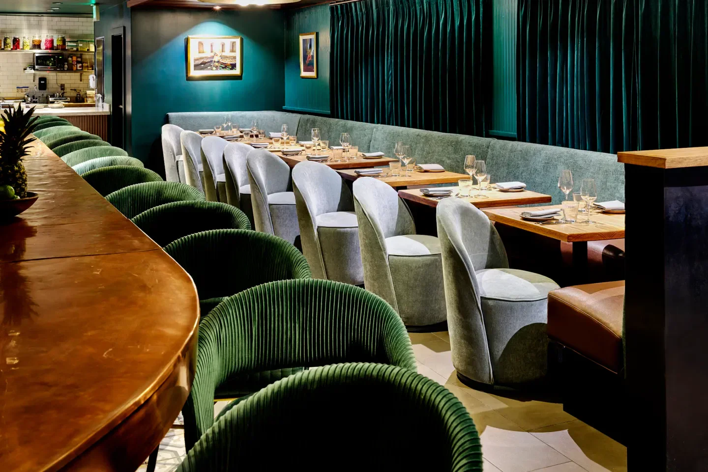 Cozy dining area at TIYA restaurant in San Francisco with stylish green chairs and decor