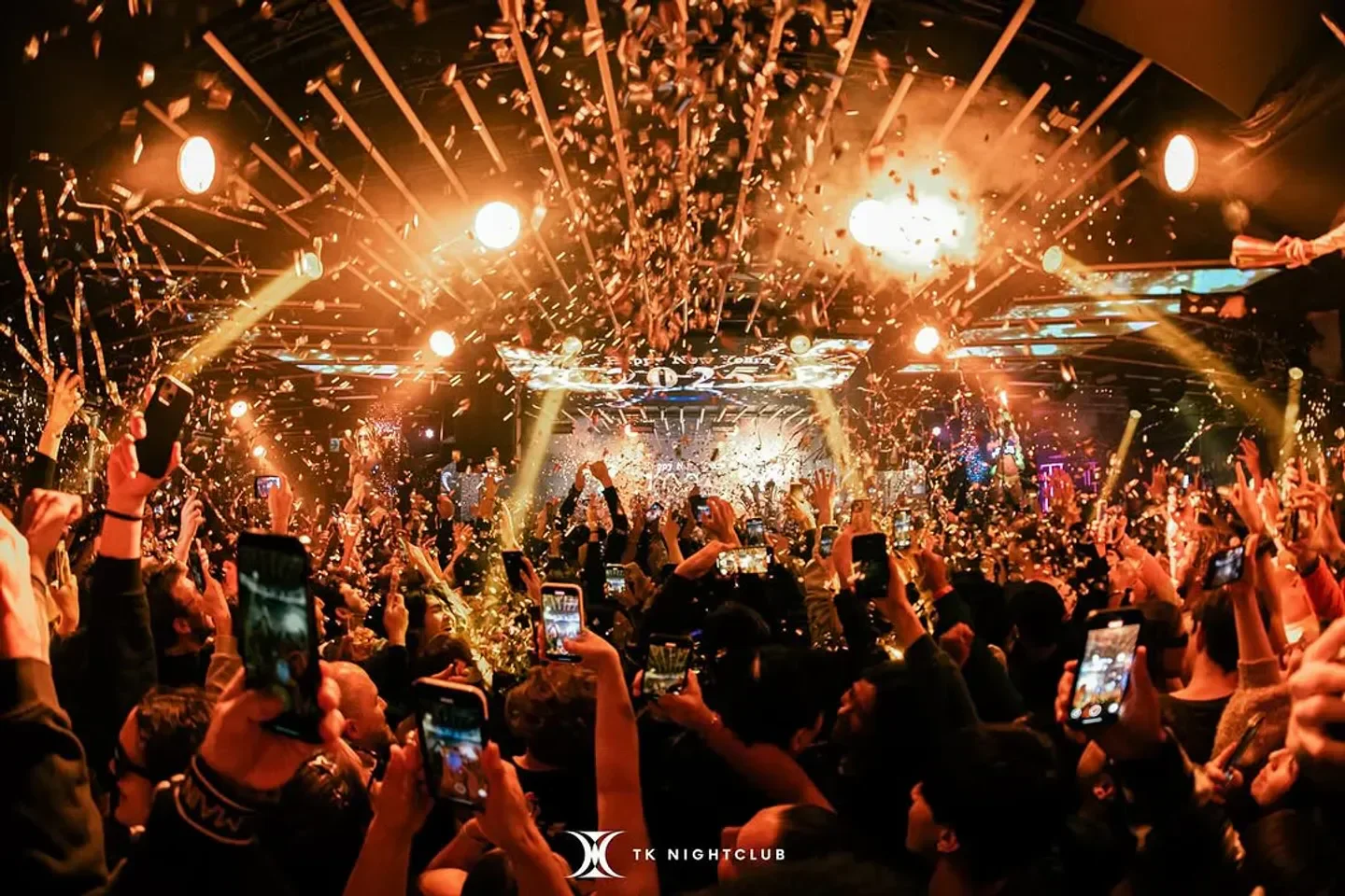 Confetti celebration at TK nightclub in Tokyo, as crowd captures the moment with phones.