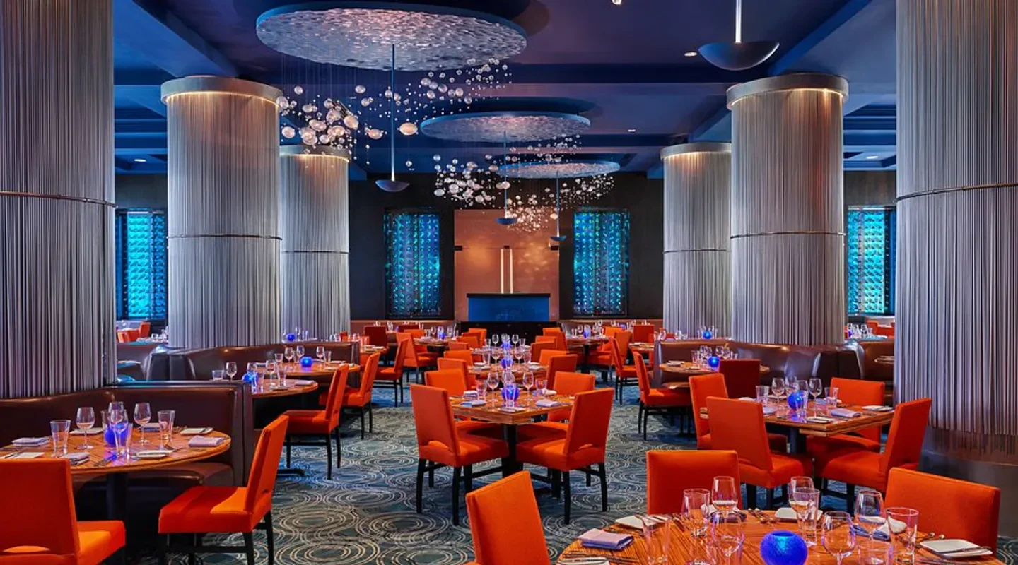 Interior of Todd English's Bluezoo restaurant in Orlando, with stylish orange seating.