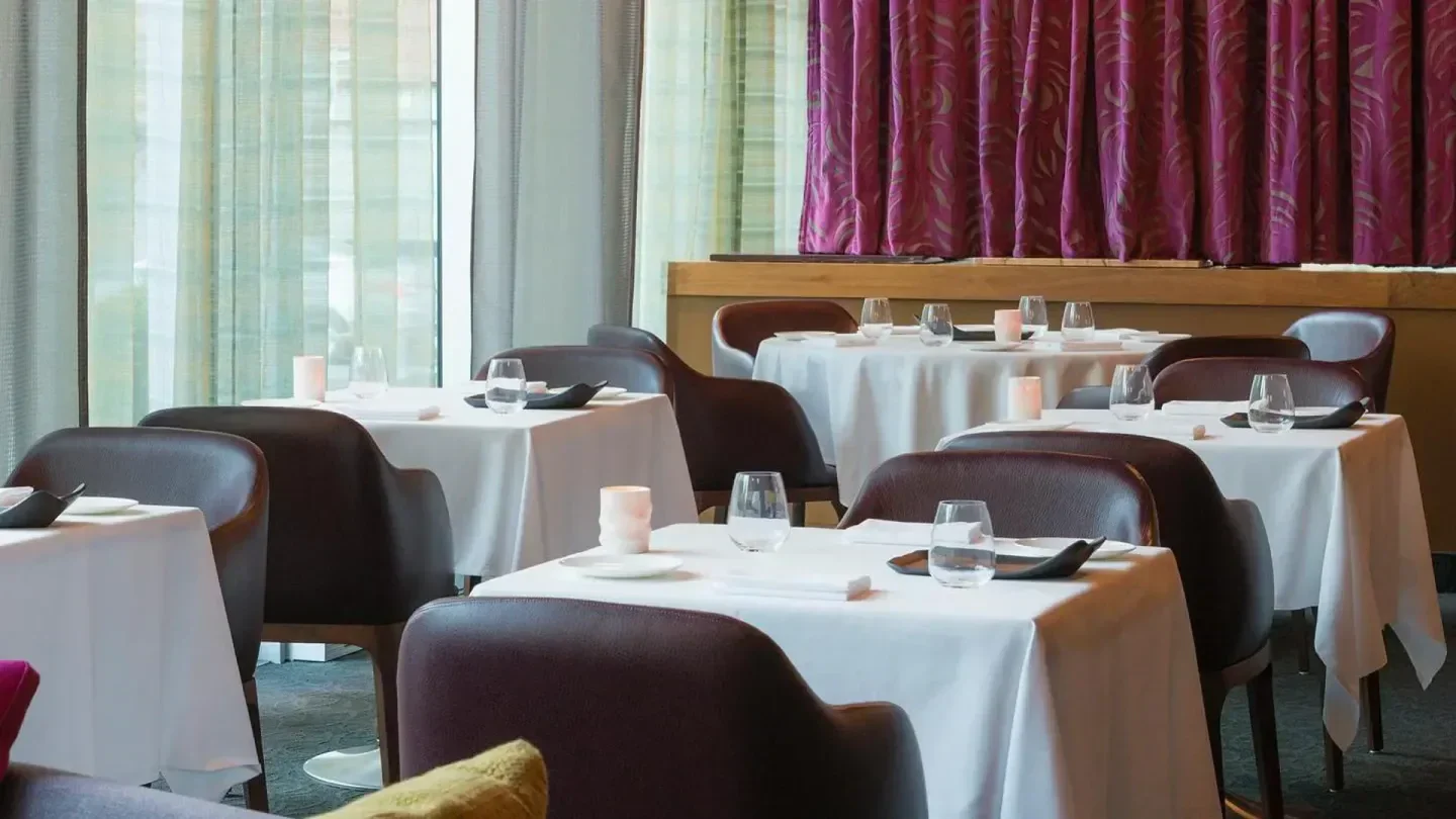 Interior of Toqué! restaurant in Montreal, featuring elegant tables and ambiance.
