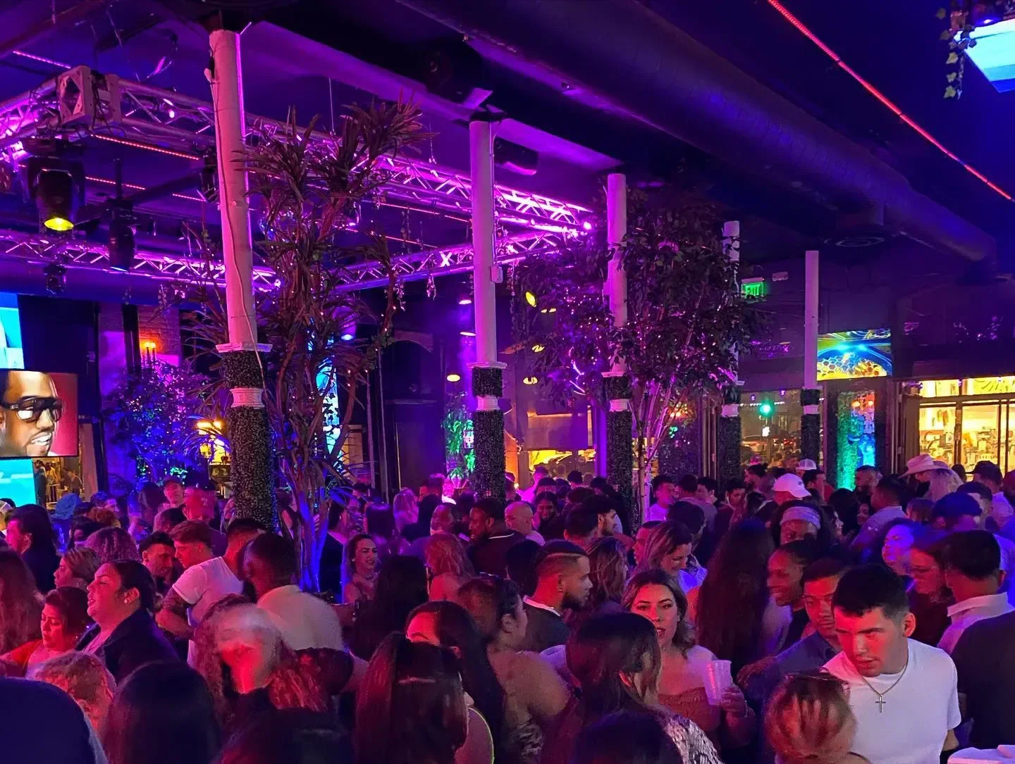 Crowded dance floor at TORO Nightclub in San Diego with purple and blue lighting.