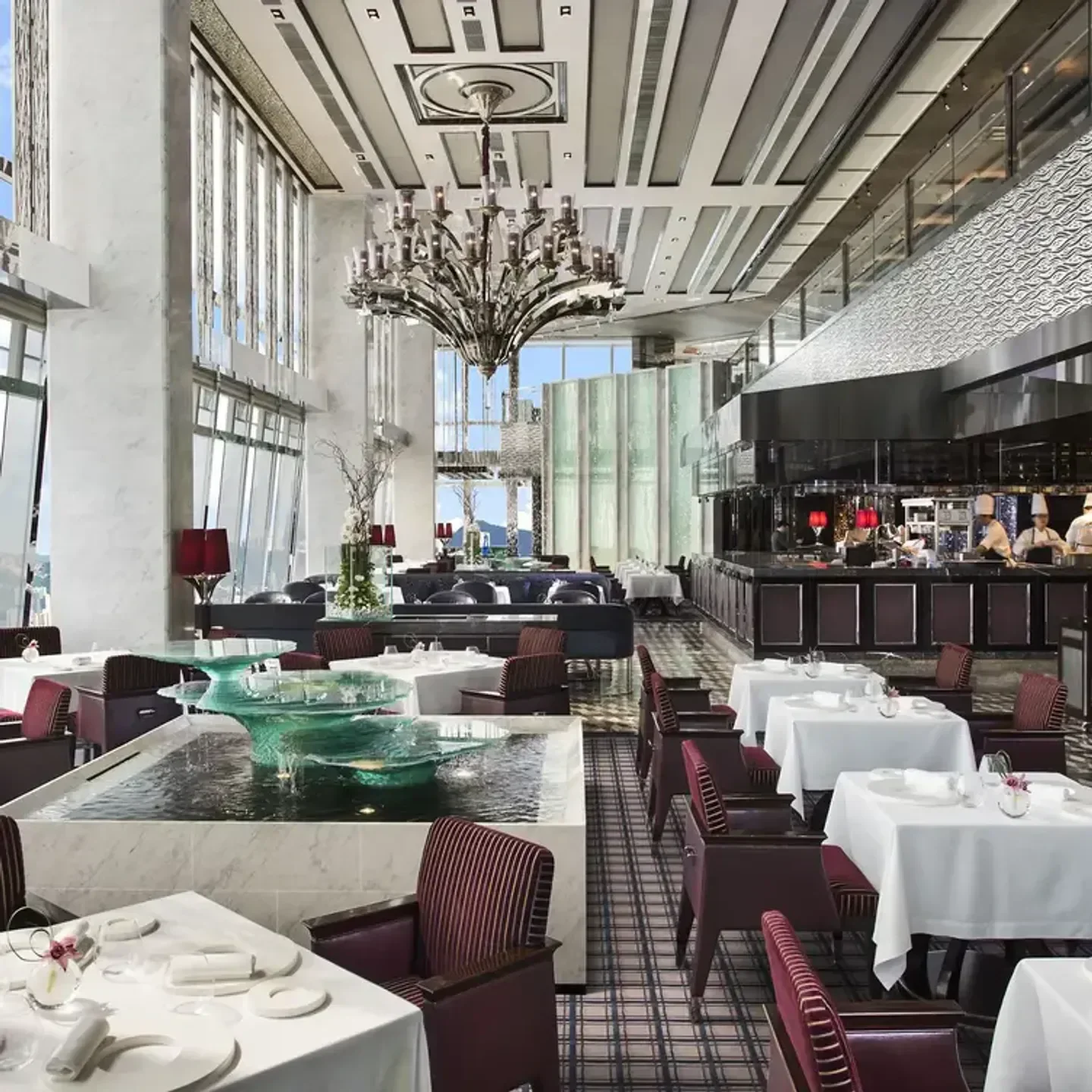 Elegant dining room at Tosca di Angelo, Hong Kong, with unique water feature and chandeliers.