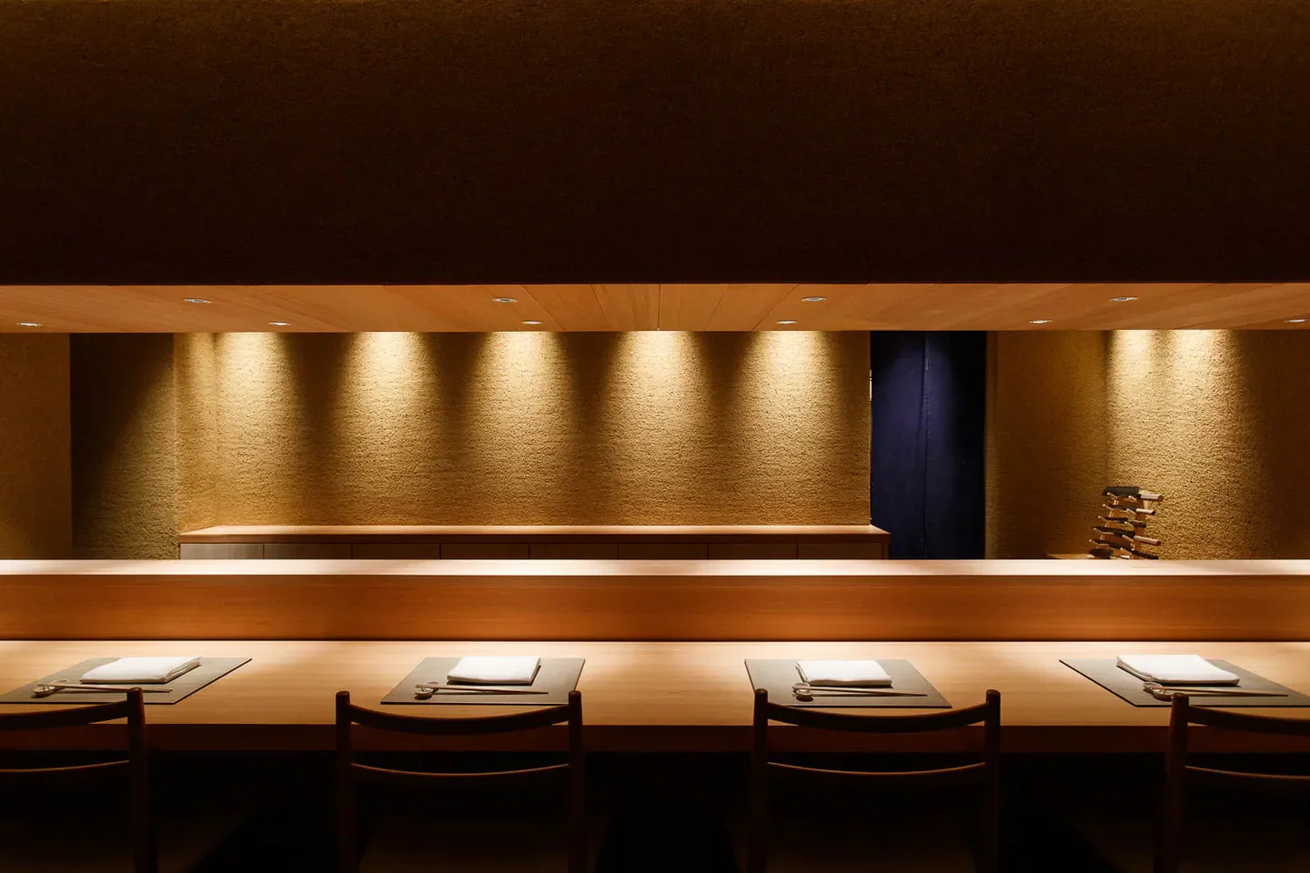 Interior of Towa restaurant in Tokyo, showcasing minimalist design and elegant dining setup.