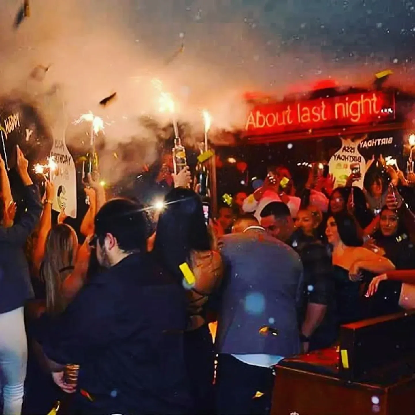 Celebratory atmosphere at Town House nightclub in Dallas, with fireworks and bottles raised.