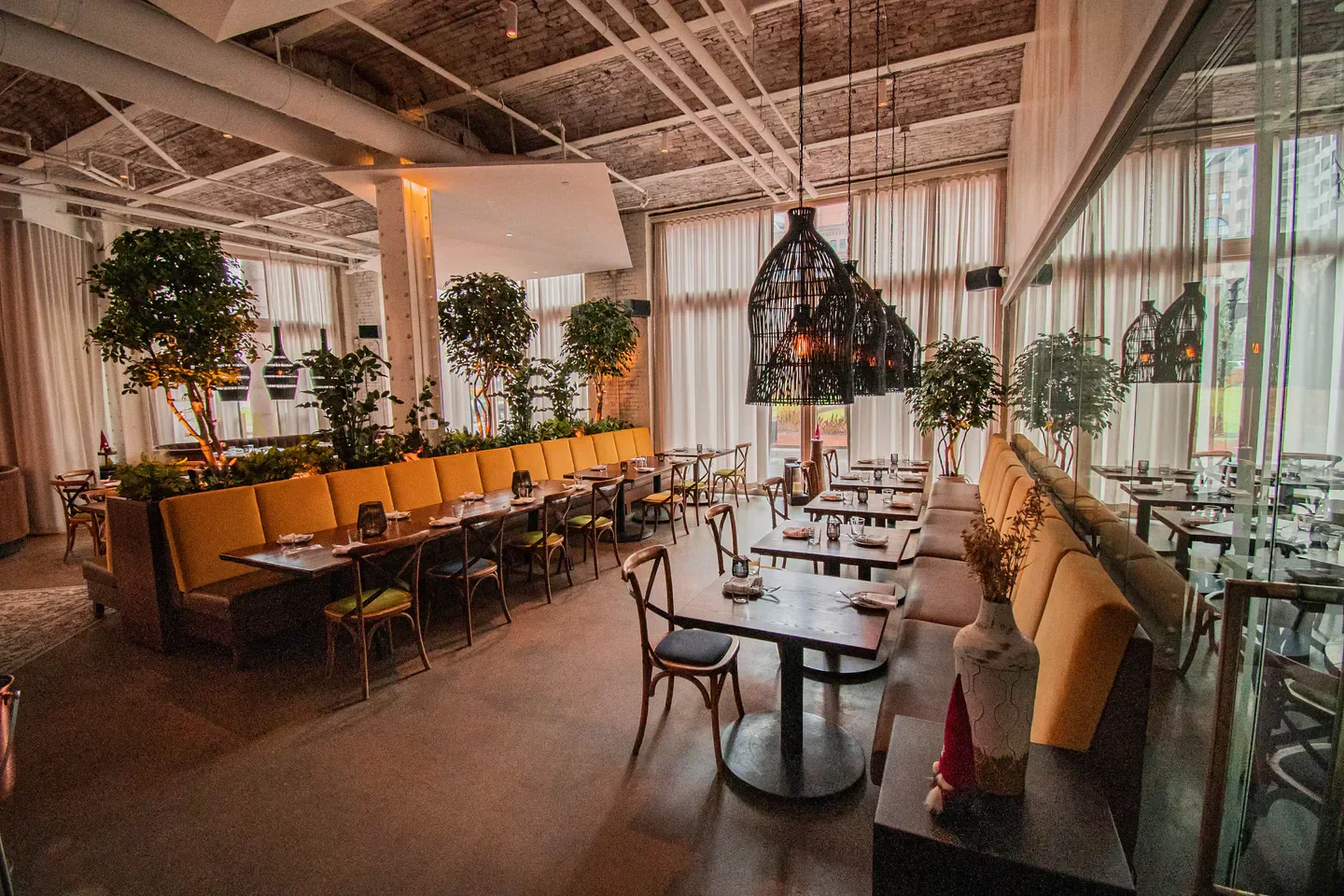 Interior of Trade restaurant in Boston, featuring stylish seating and unique lighting.