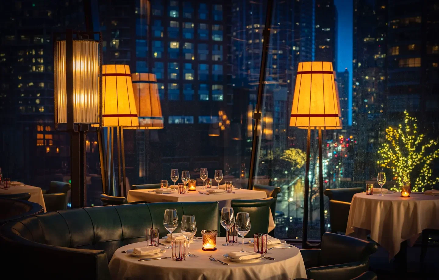 Cozy dining room at Tre Dita in Chicago with city views and table settings.
