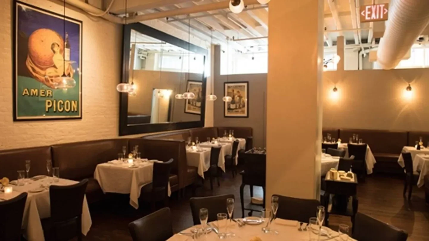 Interior dining area at Troquet on South in Boston, showcasing elegant table settings.