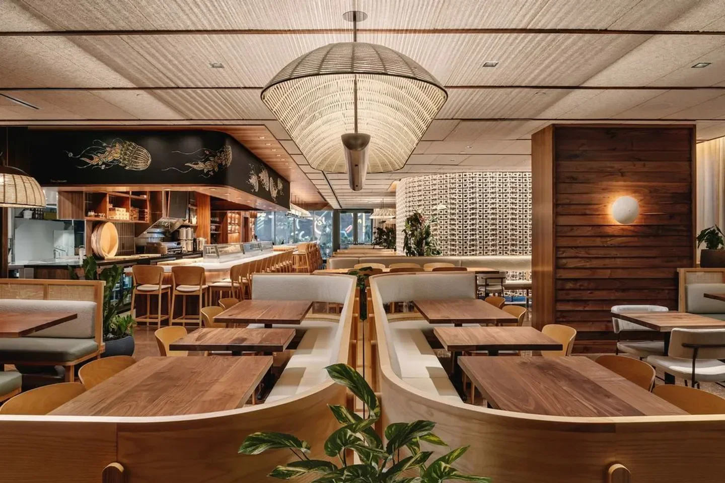 Interior of Uchi restaurant in Austin with wooden tables and decorative jellyfish artwork.