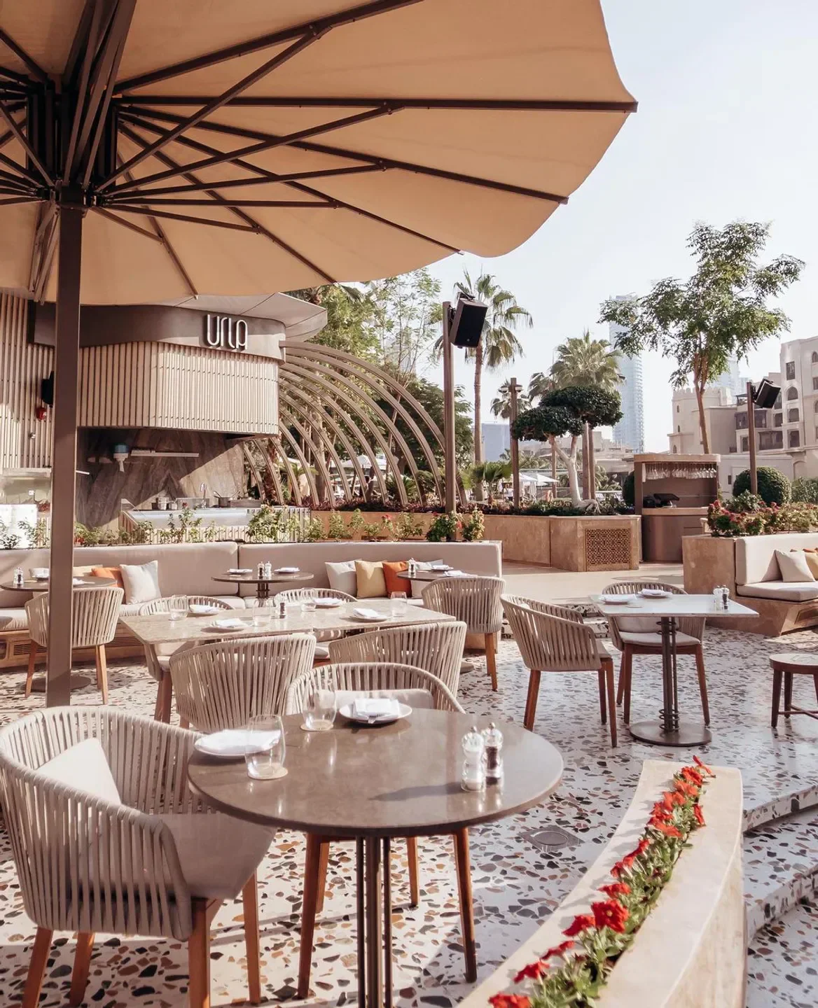 Outdoor seating at URLA restaurant in Dubai, featuring stylish chairs and tables.