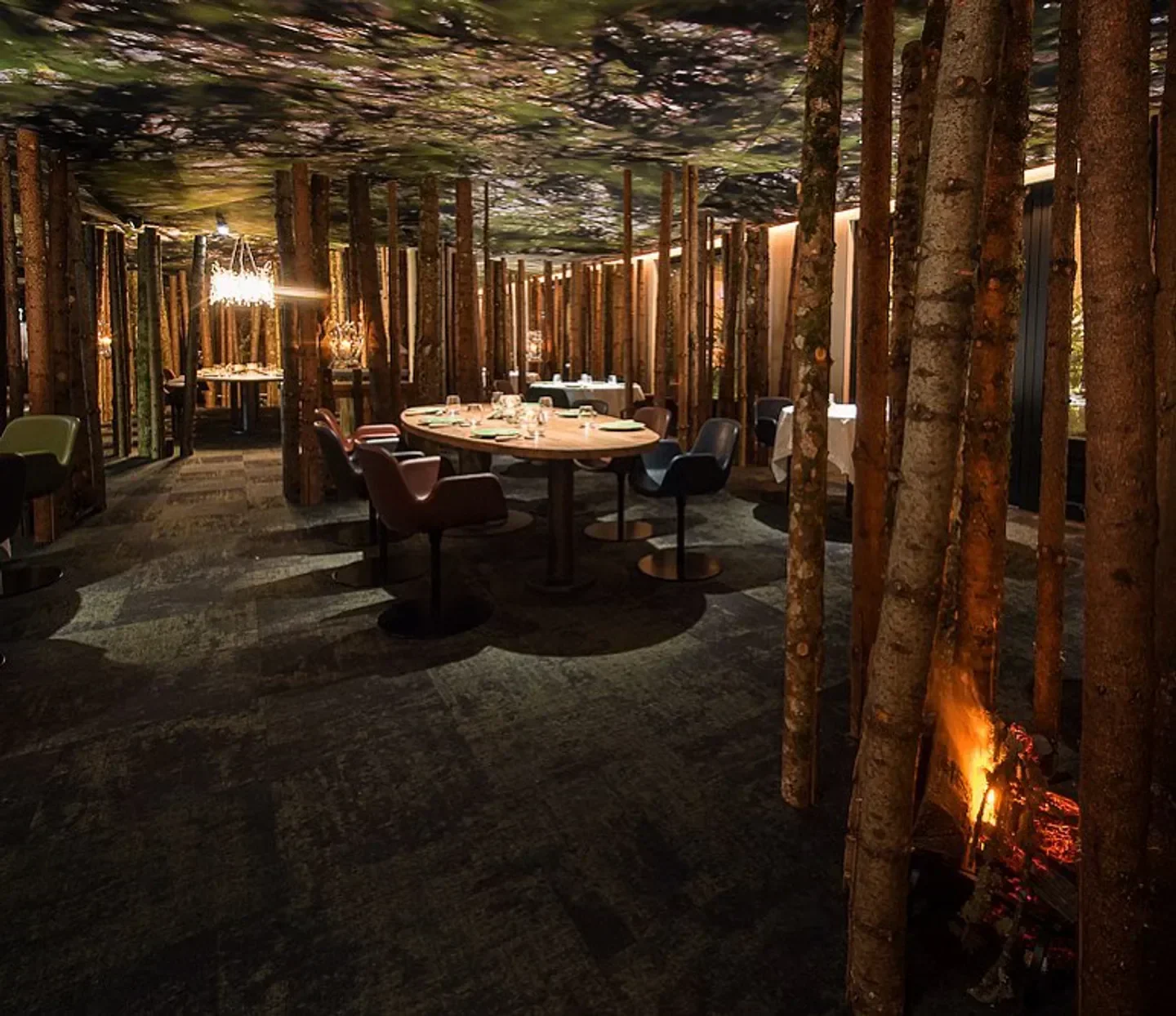 Unique interior of Ursus restaurant in Tignes, featuring tree trunks and a cozy atmosphere.