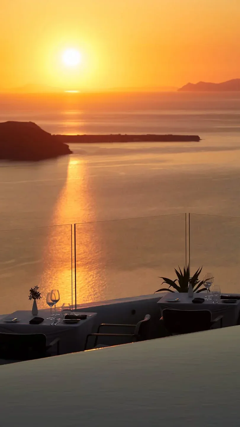 Romantic sunset dinner table at Varoulko restaurant overlooking the caldera in Santorini