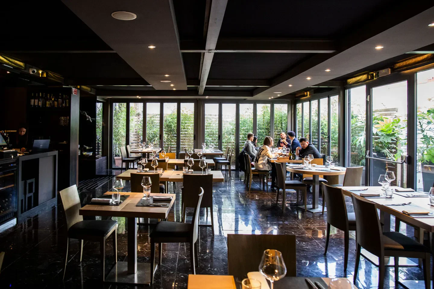 Elegant dining at Varrone restaurant in Milan, featuring stylish interior and outdoor views.