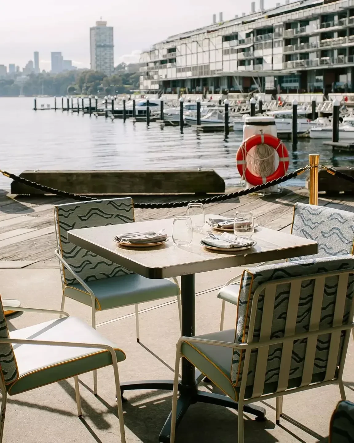Outdoor dining at Ventuno restaurant in Sydney, with waterfront views and stylish seating.