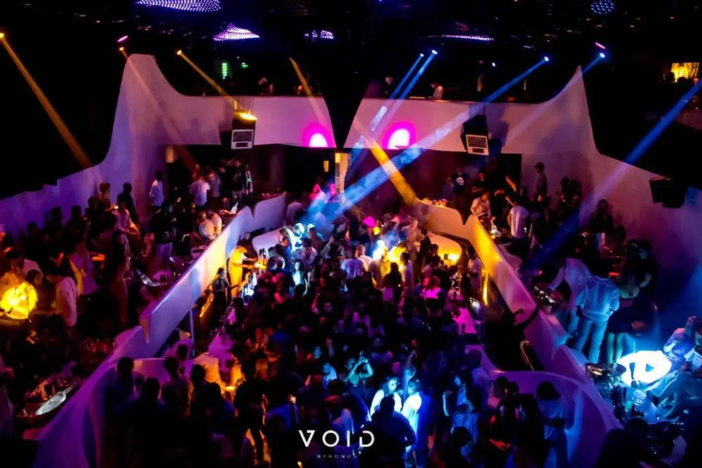 Inside VOID Mykonos nightclub, a crowded dance floor with vibrant lighting and a great atmosphere.