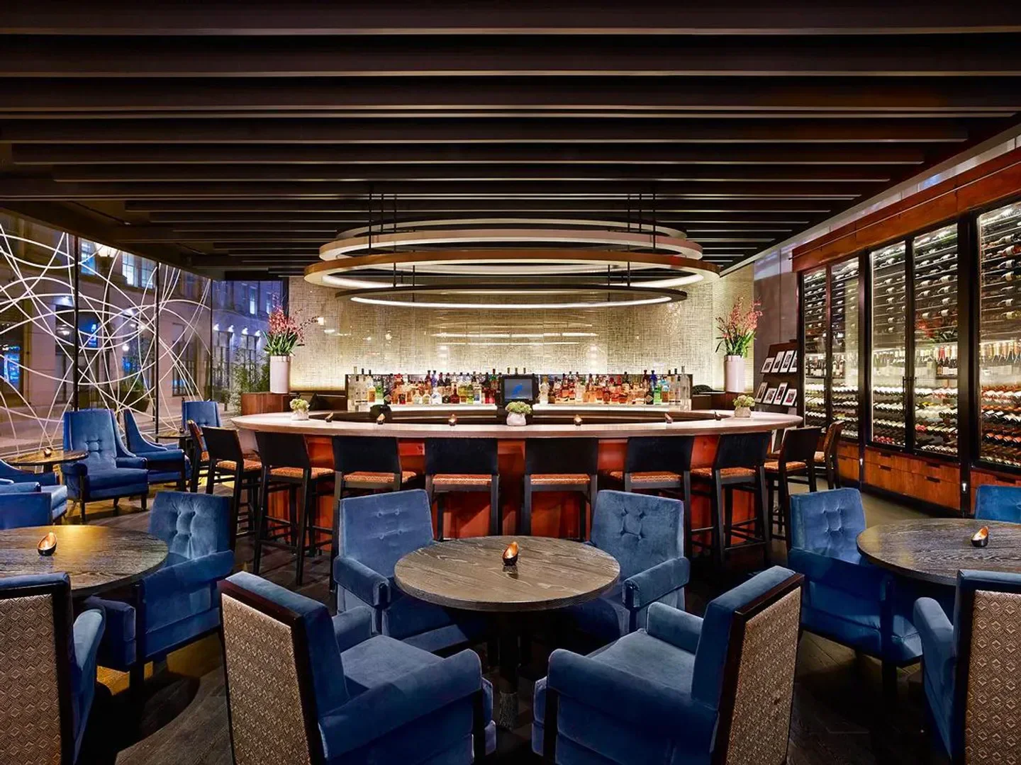 Interior view of the bar at Volver restaurant in Philadelphia, featuring blue chairs and stylish design