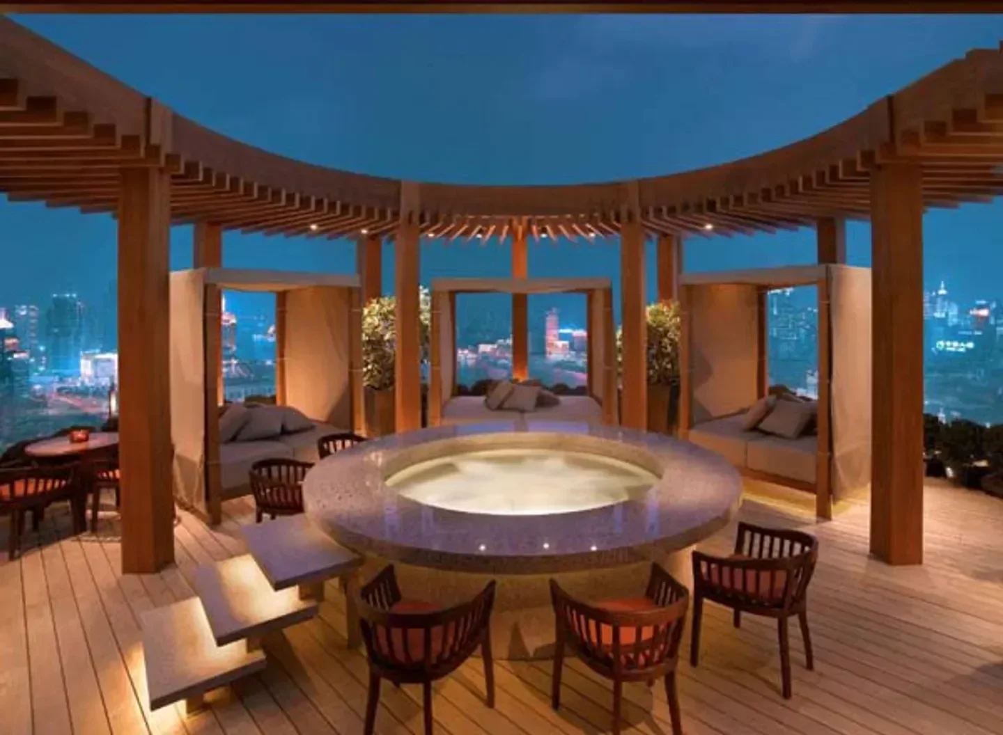 Vue Bar Shanghai, stylish rooftop restaurant with a hot tub and city views at night.