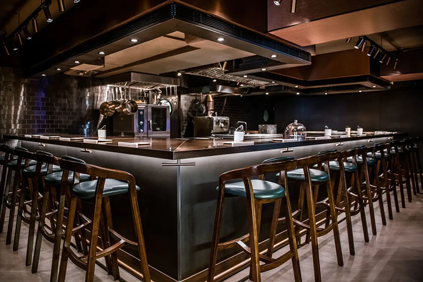 Interior view of WAGYUMAFIA restaurant in Tokyo with bar seating and kitchen view.
