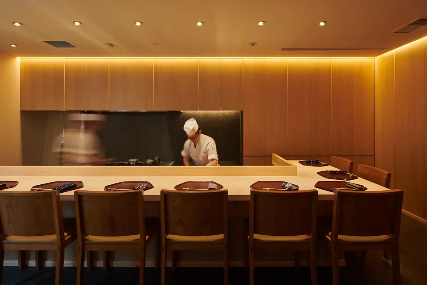 Chef preparing a meal at Waketokuyama restaurant in Tokyo, showcasing elegant dining experience.