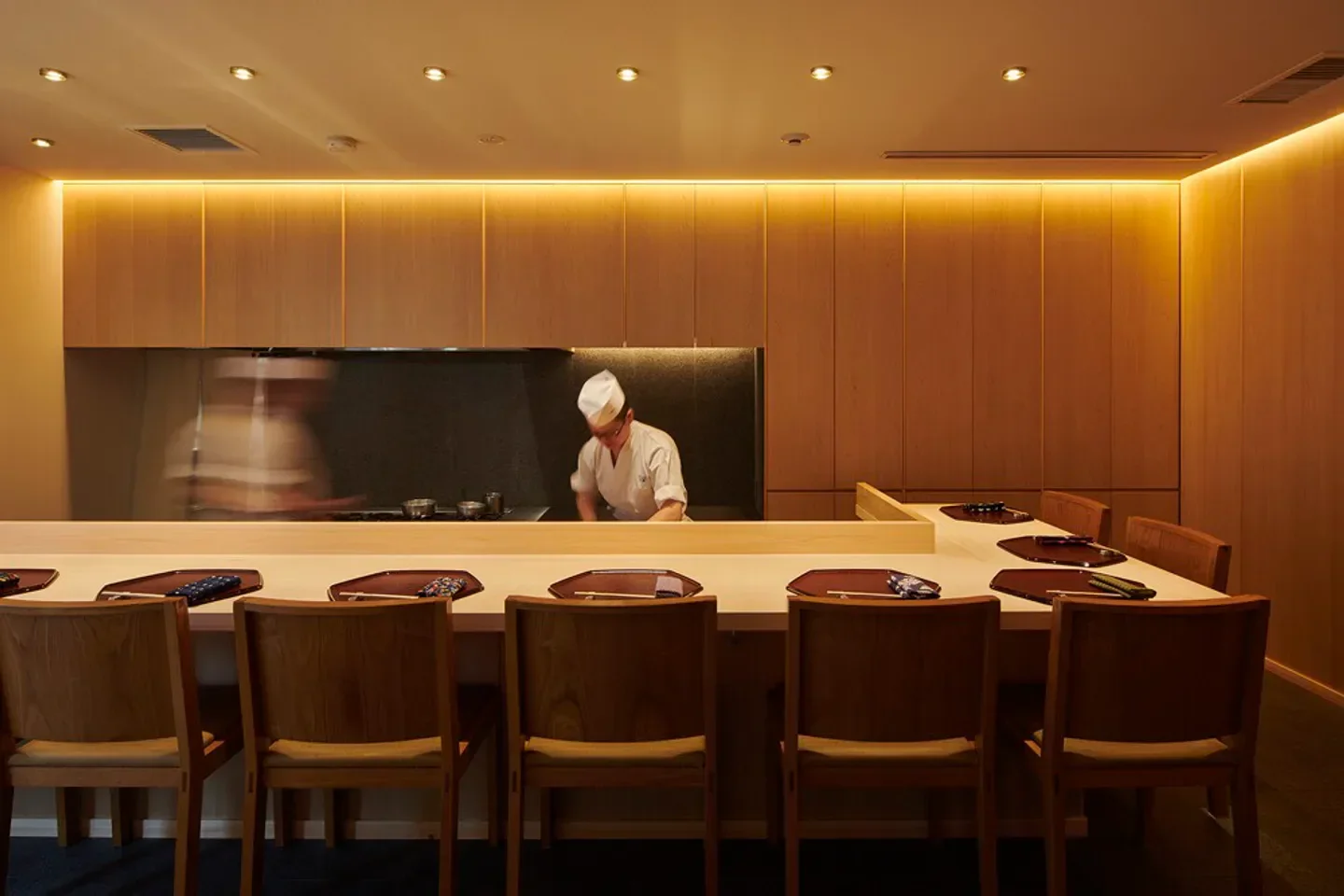 Chef preparing a meal at Waketokuyama restaurant in Tokyo, showcasing elegant dining experience.
