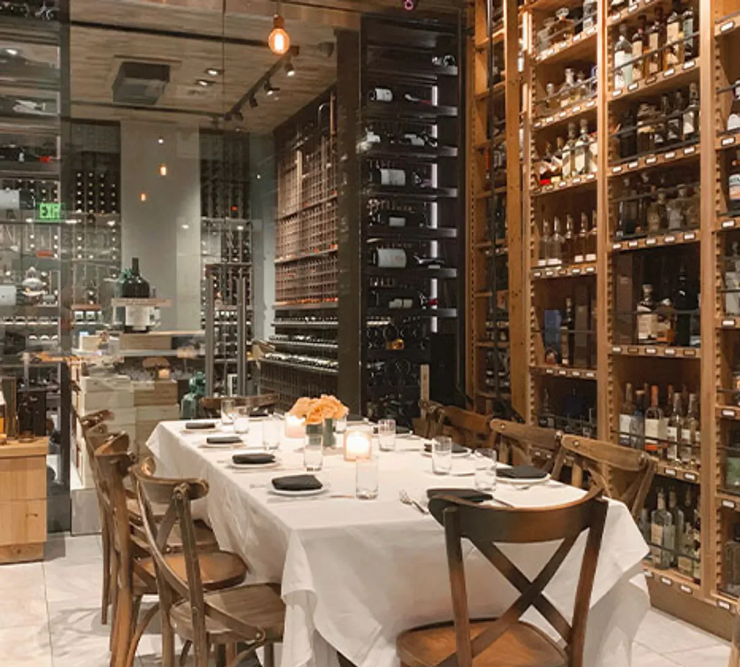 Elegant dining at Wally's Las Vegas, surrounded by extensive wine and spirit selection.
