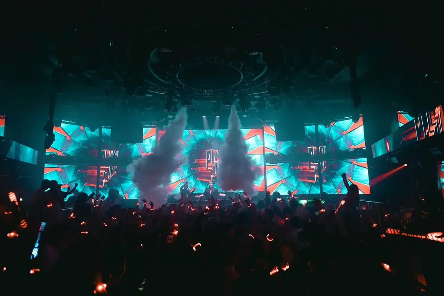 Energetic crowd at WARP nightclub in Tokyo, enjoying a vibrant party atmosphere.