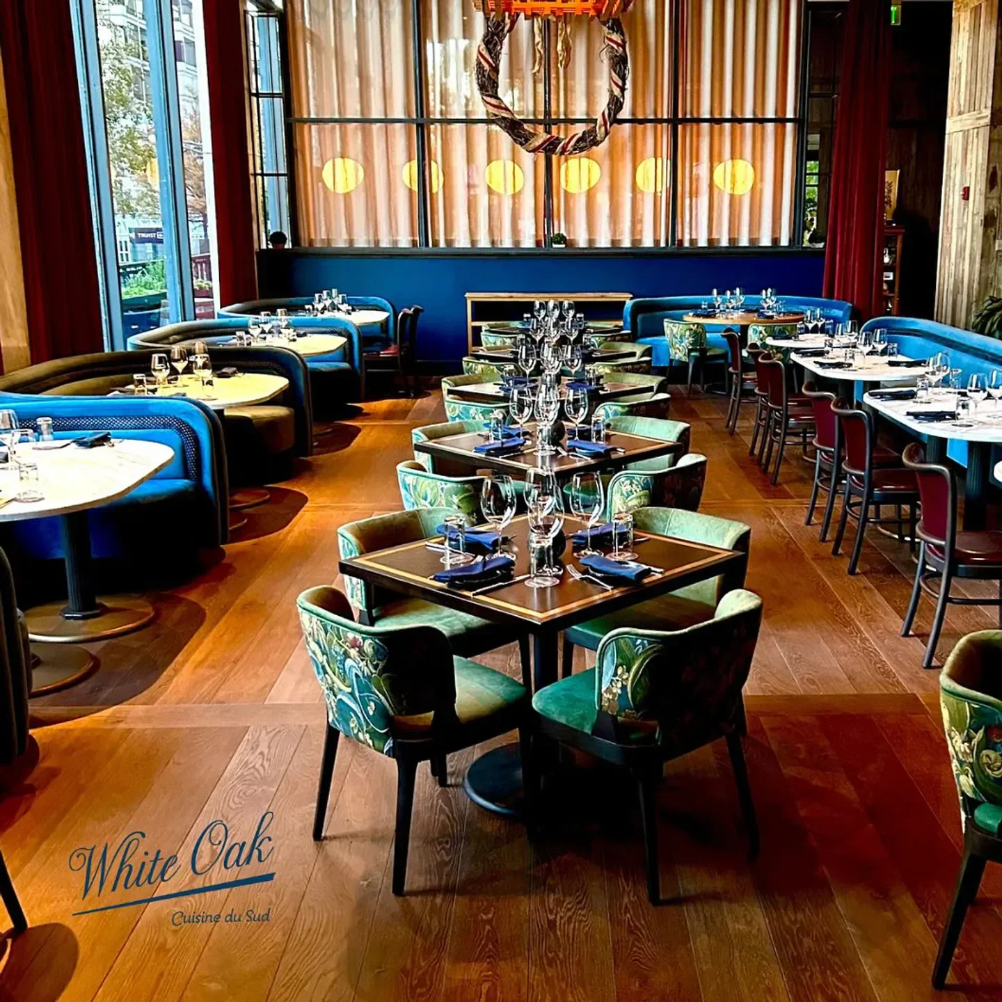 Interior of White Oak Kitchen & Cocktails in Atlanta, featuring stylish seating and table settings.