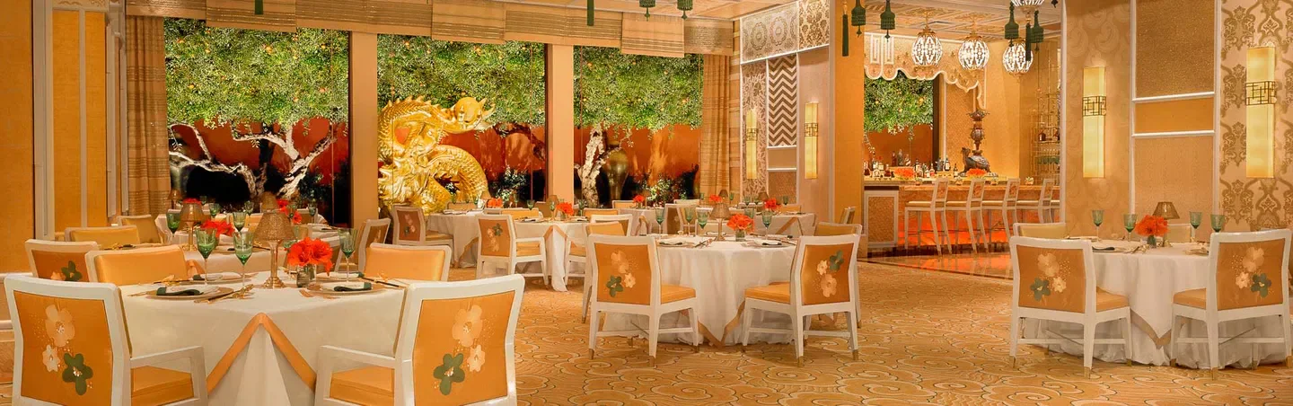 Elegant dining room at Wing Lei, Las Vegas, with golden dragon decor