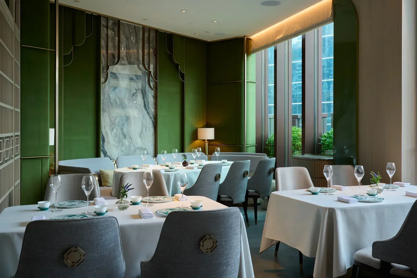 Elegant dining room at WING Restaurant in Hong Kong, with tables set for guests.