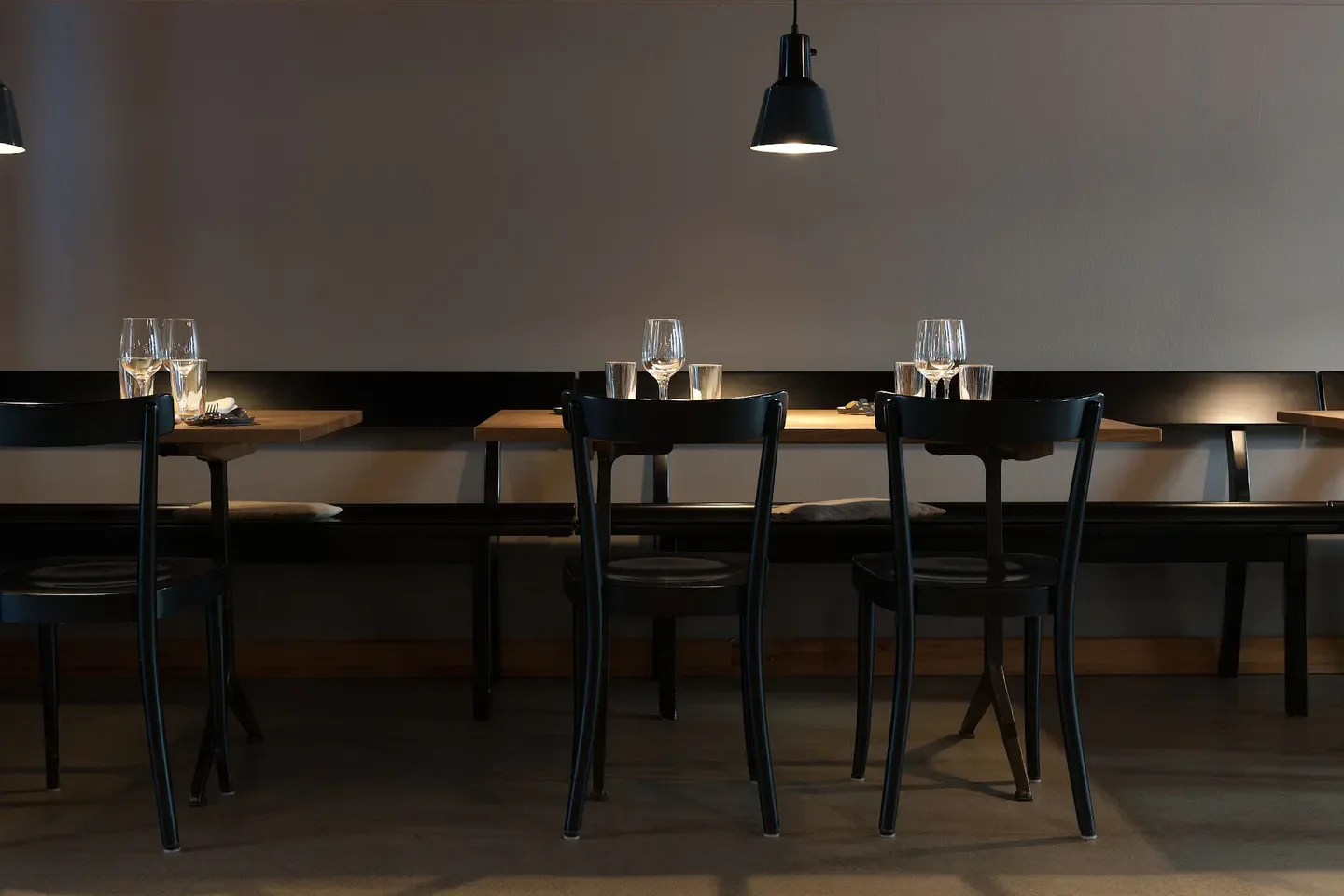 Interior of Wirtschaft im FRANZ restaurant in Zurich, featuring tables, chairs, and lighting.