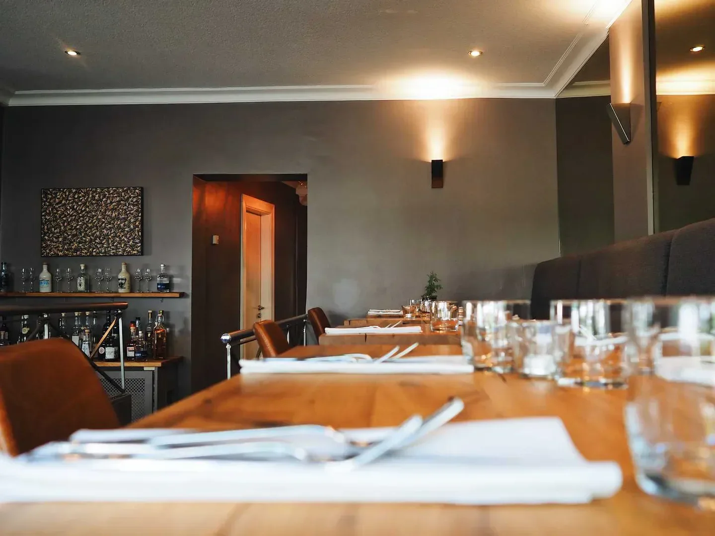 Interior of Wolfs Junge restaurant in Hamburg, showing tables set for dining